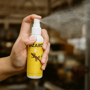Lizard repellent spray being applied to a suitable indoor area.