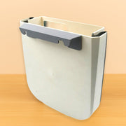 Compact hanging trash can installed in a car, keeping the interior tidy.