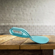 Mattress lifter tool positioned beneath a mattress edge for bed making.